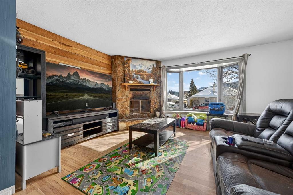 7705 24 Avenue, Coleman, AB - Indoor Photo Showing Living Room With Fireplace