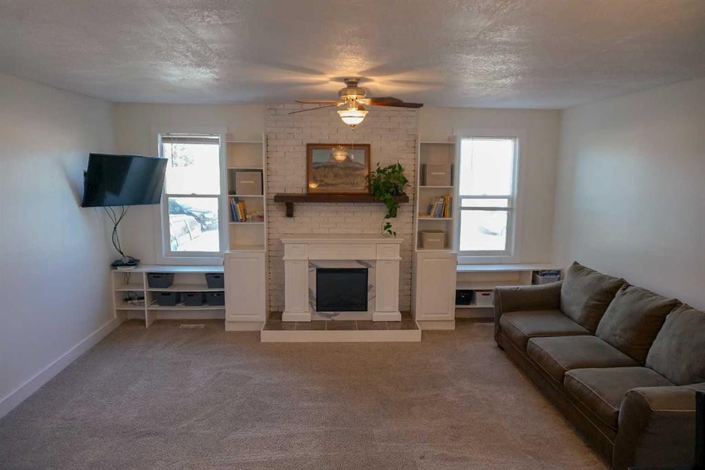 206 Mcgill Boulevard West, Lethbridge, AB - Indoor Photo Showing Living Room With Fireplace