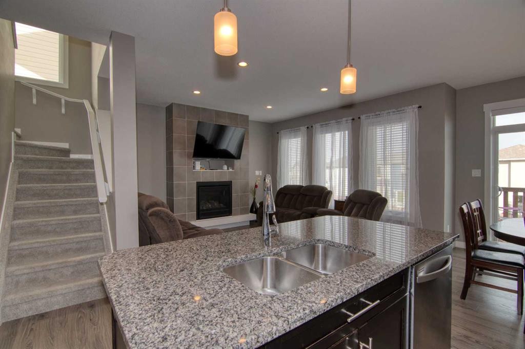 559 Moonlight Lane West, Lethbridge, AB - Indoor Photo Showing Kitchen With Fireplace With Double Sink