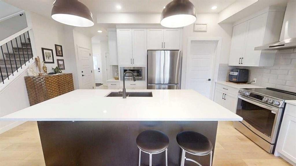 28 Aster Link, Okotoks, AB - Indoor Photo Showing Kitchen With Double Sink With Upgraded Kitchen