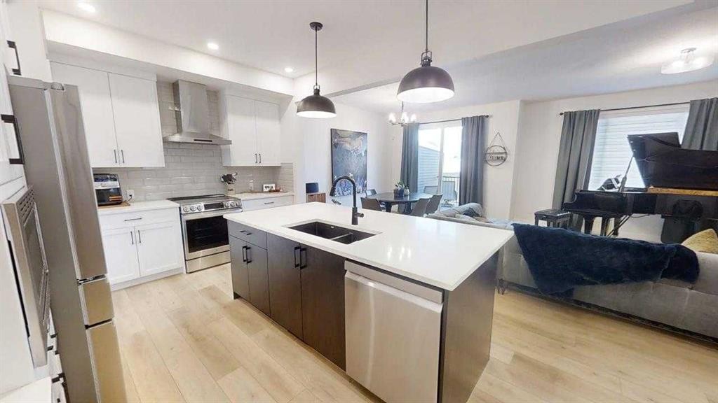 28 Aster Link, Okotoks, AB - Indoor Photo Showing Kitchen With Double Sink With Upgraded Kitchen