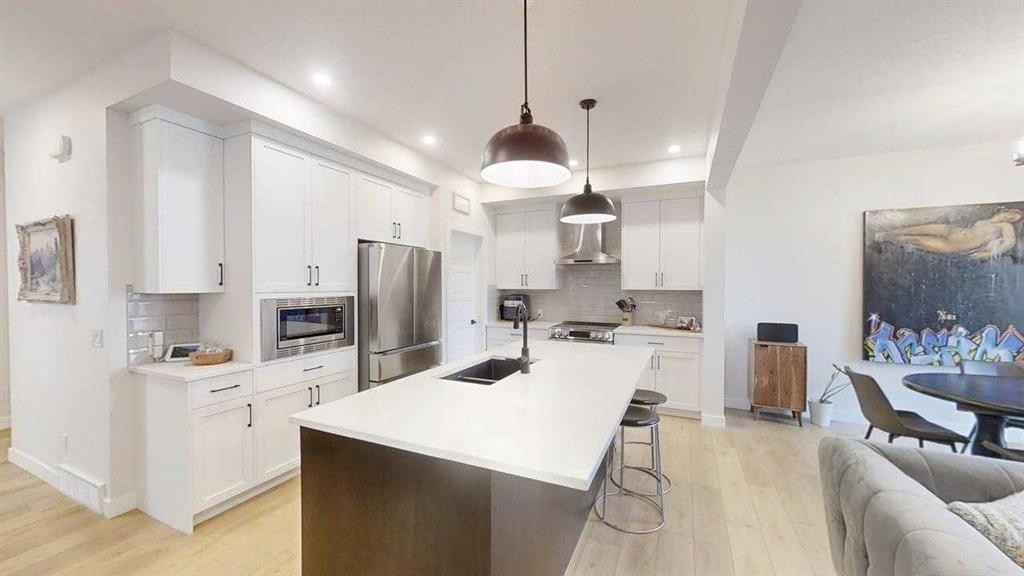 28 Aster Link, Okotoks, AB - Indoor Photo Showing Kitchen With Double Sink With Upgraded Kitchen