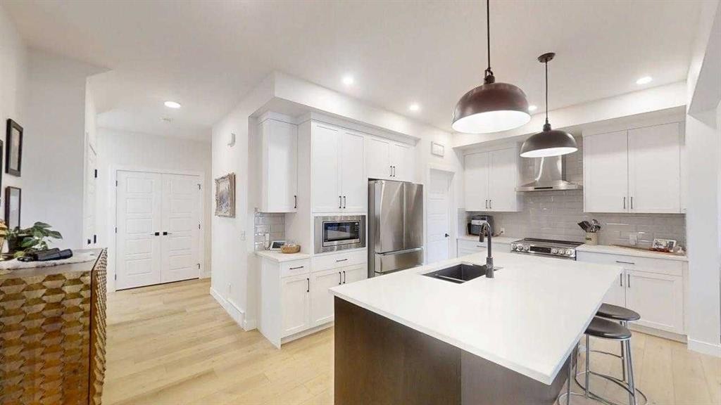 28 Aster Link, Okotoks, AB - Indoor Photo Showing Kitchen With Double Sink With Upgraded Kitchen