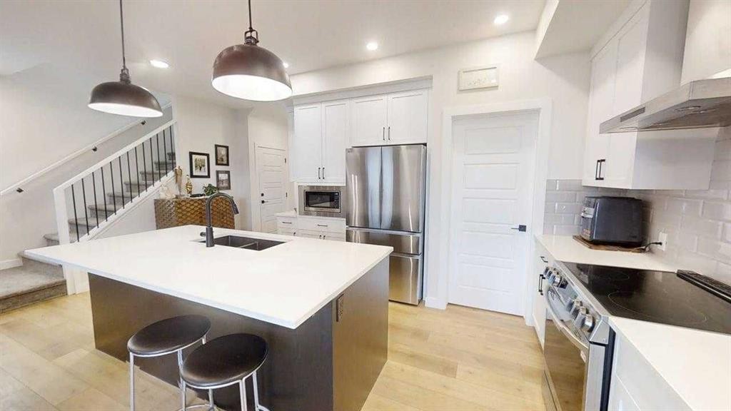 28 Aster Link, Okotoks, AB - Indoor Photo Showing Kitchen With Double Sink With Upgraded Kitchen
