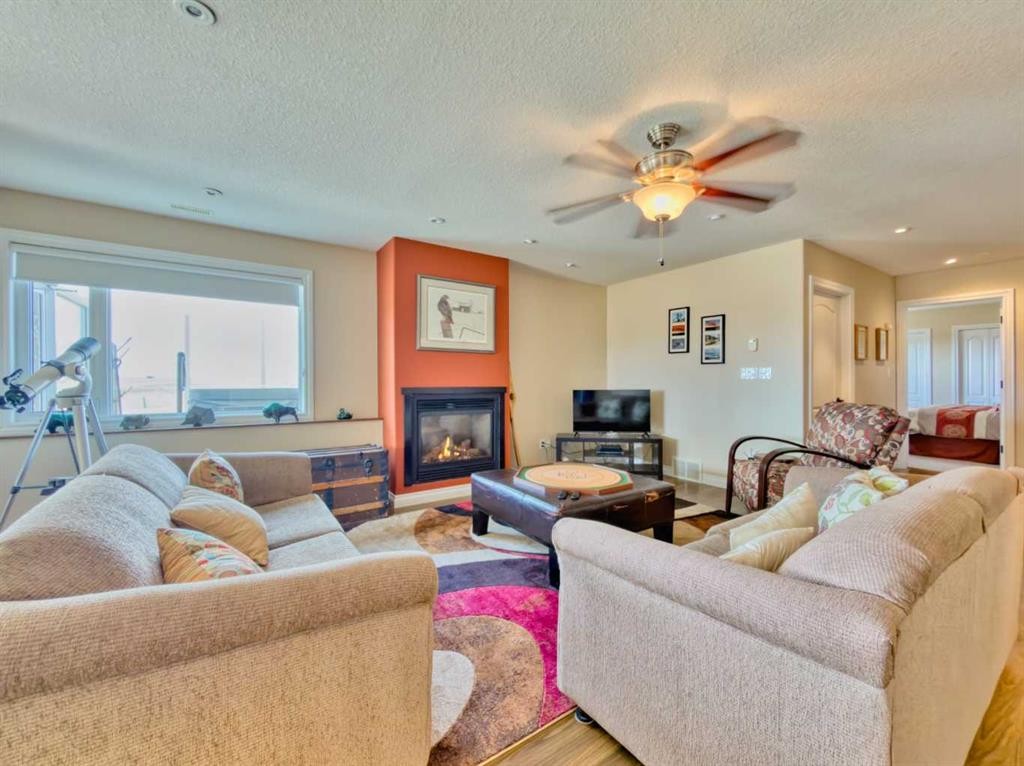 5 Walking Plow Estates, Cowley, AB - Indoor Photo Showing Living Room With Fireplace