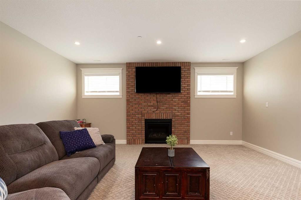 1 Edgemoor Way West, Lethbridge, AB - Indoor Photo Showing Living Room With Fireplace
