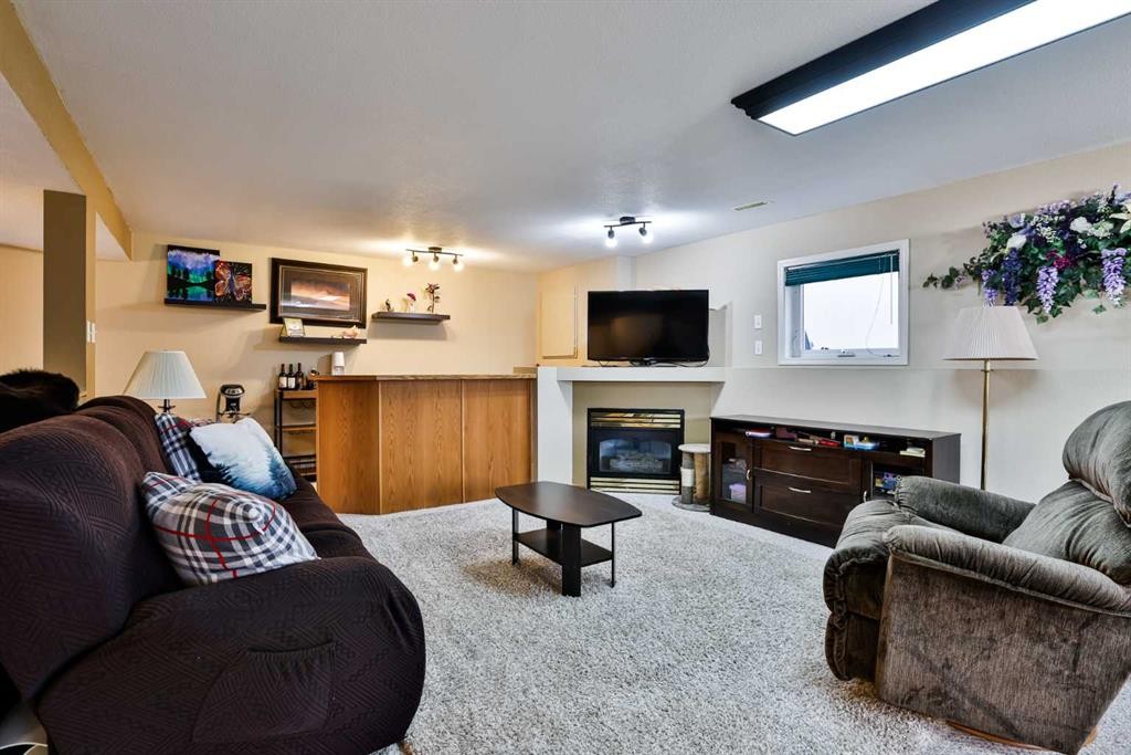 263 Red Crow Boulevard West, Lethbridge, AB - Indoor Photo Showing Living Room With Fireplace