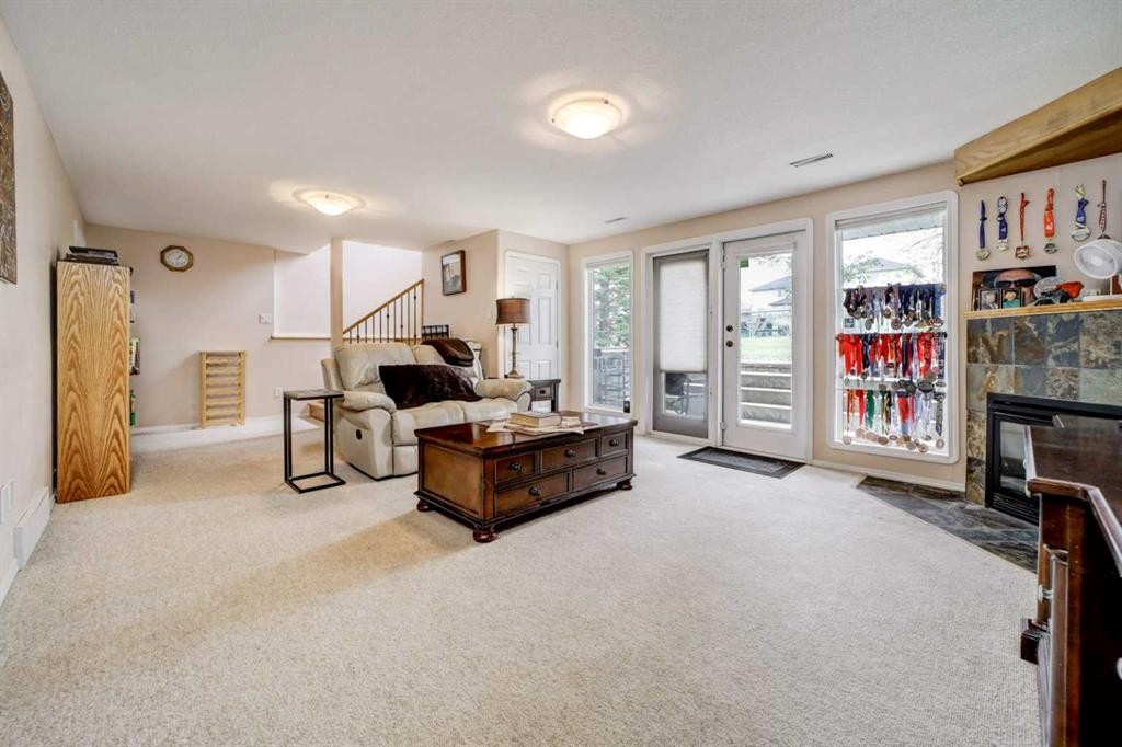 50 Sarcee Place West, Lethbridge, AB - Indoor Photo Showing Living Room With Fireplace