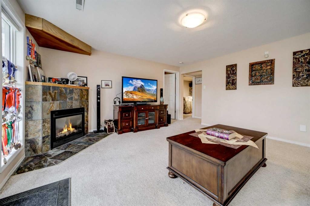50 Sarcee Place West, Lethbridge, AB - Indoor Photo Showing Living Room With Fireplace