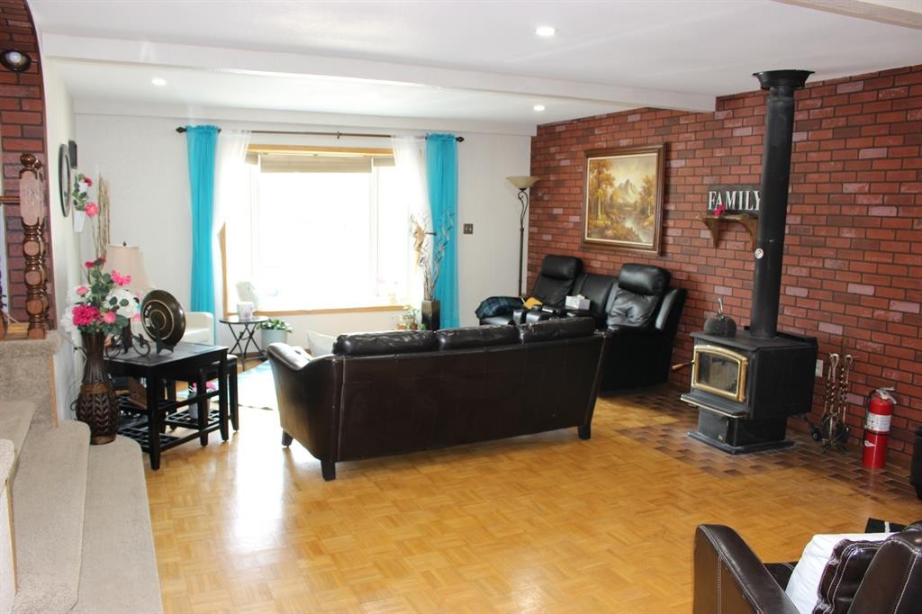 605 Rogers Avenue, Picture Butte, AB - Indoor Photo Showing Other Room With Fireplace