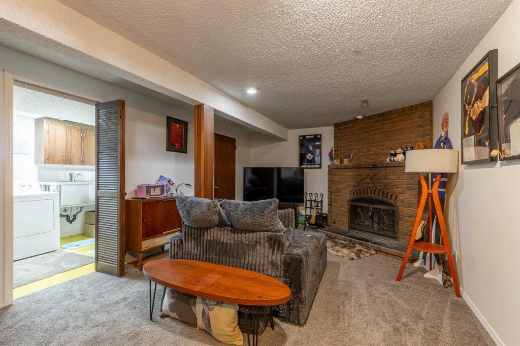 57 Honeysuckle Road North, Lethbridge, AB - Indoor Photo Showing Other Room With Fireplace