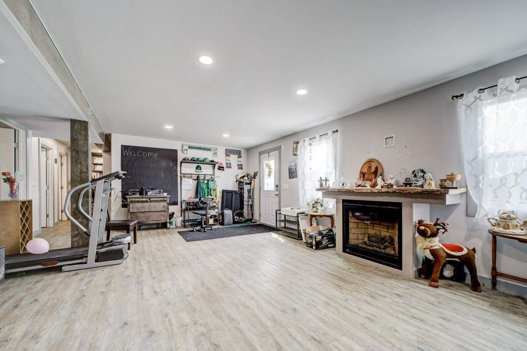 8501 21 Avenue, Coleman, AB - Indoor Photo Showing Gym Room With Fireplace