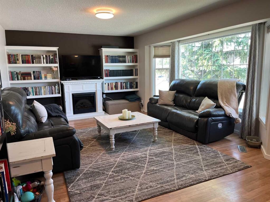 235S 50 West, Raymond, AB - Indoor Photo Showing Living Room With Fireplace
