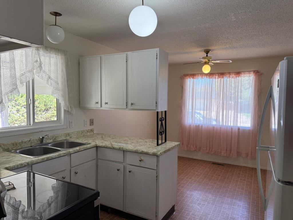 232 Rubie Crescent, Nobleford, AB - Indoor Photo Showing Kitchen With Double Sink