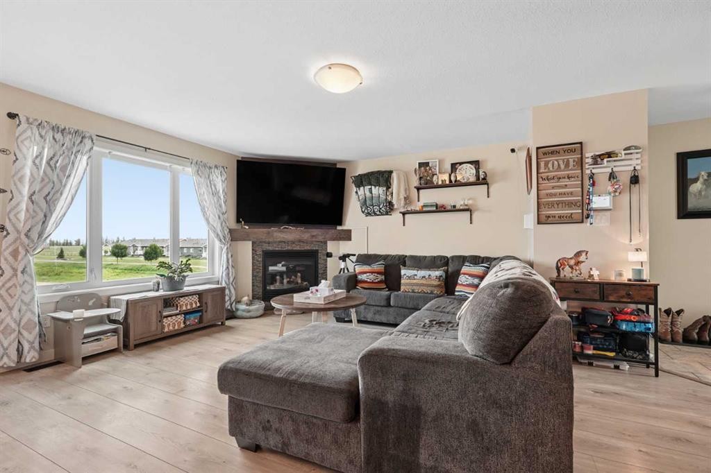 648 Parkside Green, Coaldale, AB - Indoor Photo Showing Living Room With Fireplace