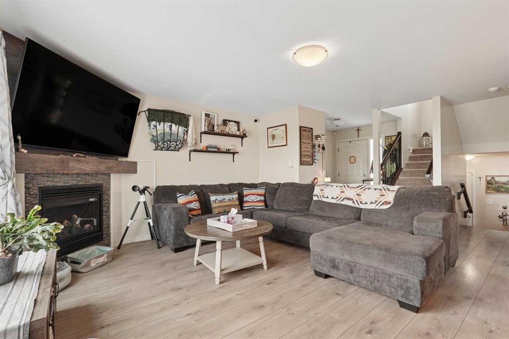 648 Parkside Green, Coaldale, AB - Indoor Photo Showing Living Room With Fireplace