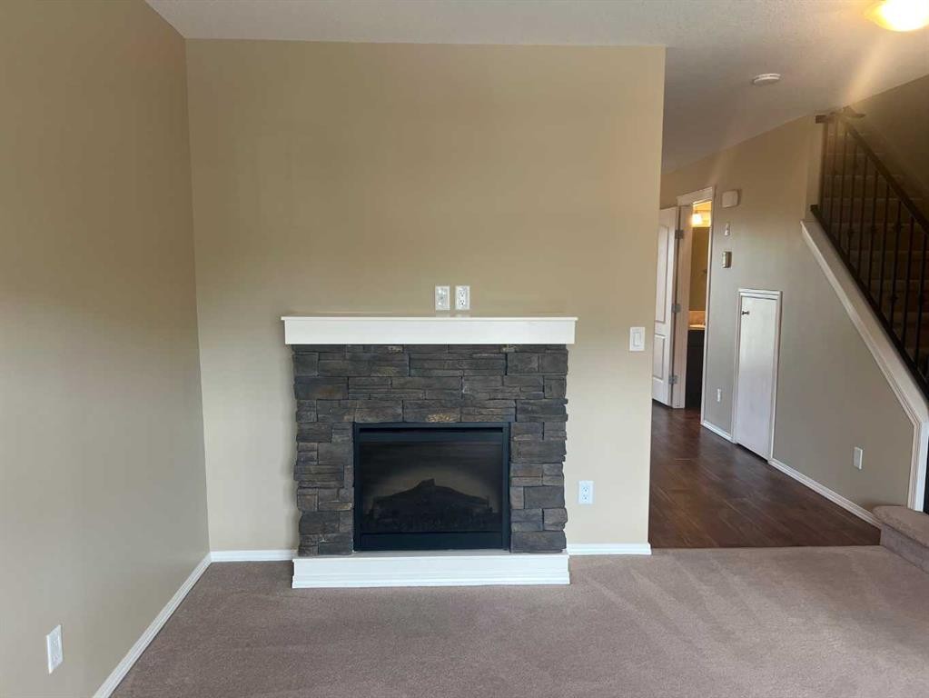 18-45 Keystone Terrace West, Lethbridge, AB - Indoor Photo Showing Living Room With Fireplace