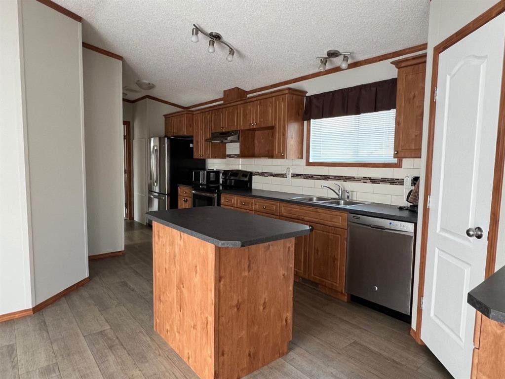 4002 Seasons Boulevard, Coaldale, AB - Indoor Photo Showing Kitchen With Double Sink