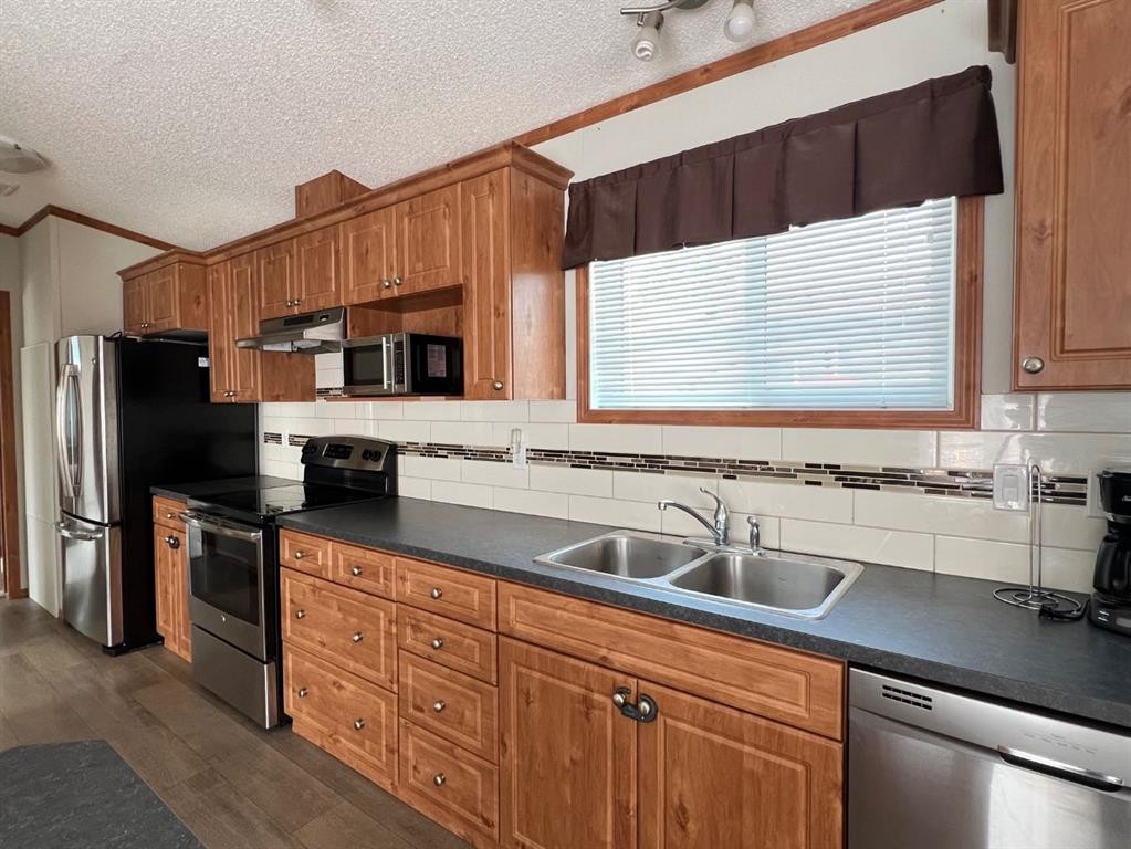 4002 Seasons Boulevard, Coaldale, AB - Indoor Photo Showing Kitchen With Stainless Steel Kitchen With Double Sink