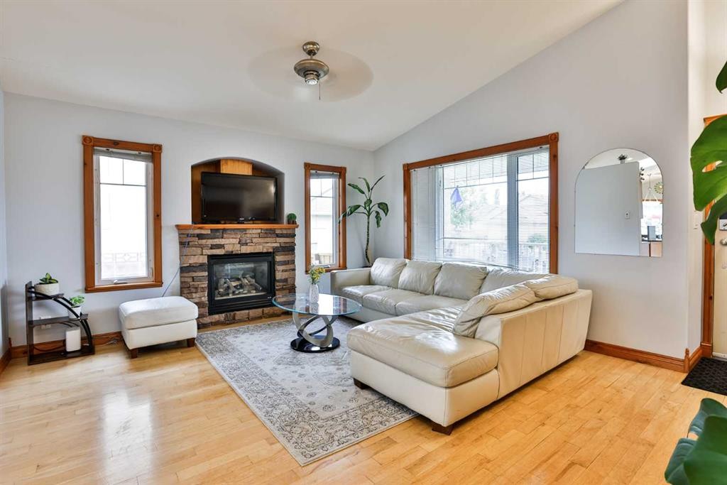 128 Cougar Road North, Lethbridge, AB - Indoor Photo Showing Living Room With Fireplace