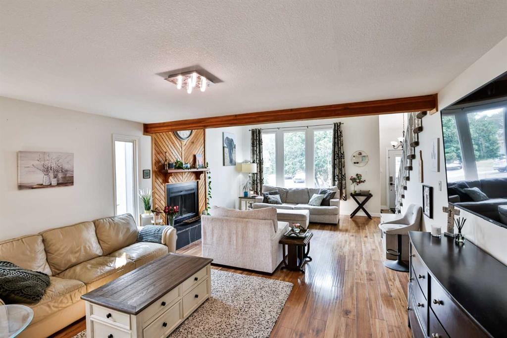 100 Eton Road West, Lethbridge, AB - Indoor Photo Showing Living Room With Fireplace