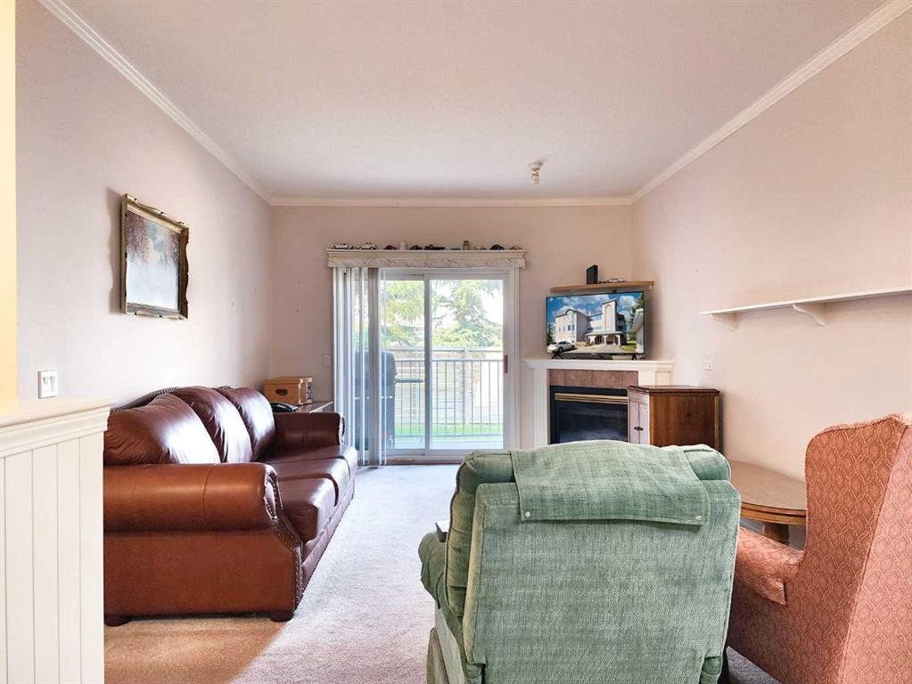 102-6 Skyline Crescent, Claresholm, AB - Indoor Photo Showing Living Room With Fireplace