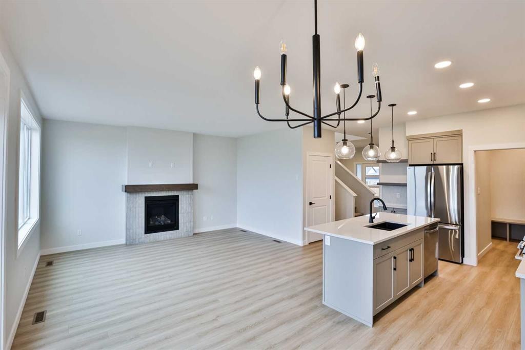 877 Devonia Circle West, Lethbridge, AB - Indoor Photo Showing Kitchen With Fireplace With Stainless Steel Kitchen With Upgraded Kitchen