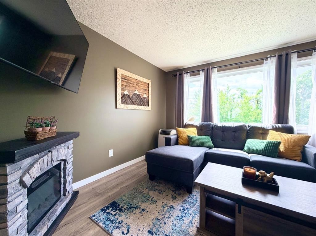 53 97 Avenue, Grande Cache, AB - Indoor Photo Showing Living Room With Fireplace