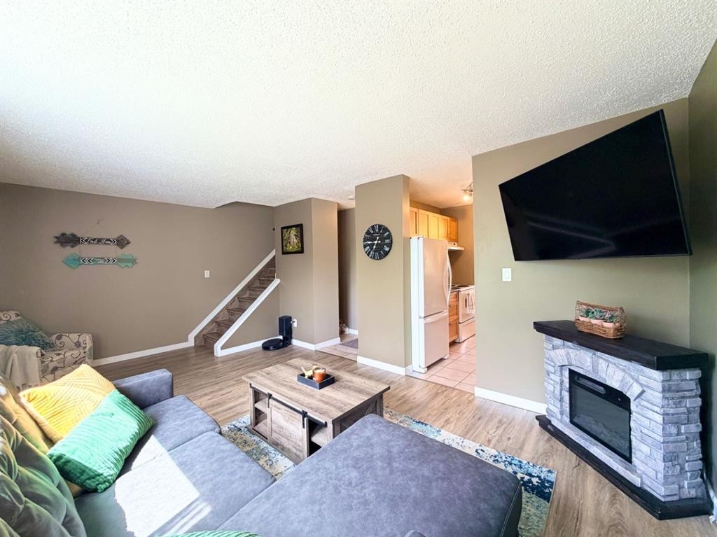 53 97 Avenue, Grande Cache, AB - Indoor Photo Showing Living Room With Fireplace