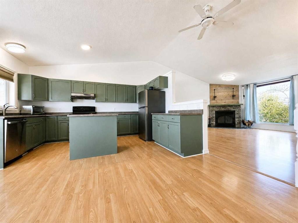 10913 Grande Avenue, Grande Cache, AB - Indoor Photo Showing Kitchen With Fireplace