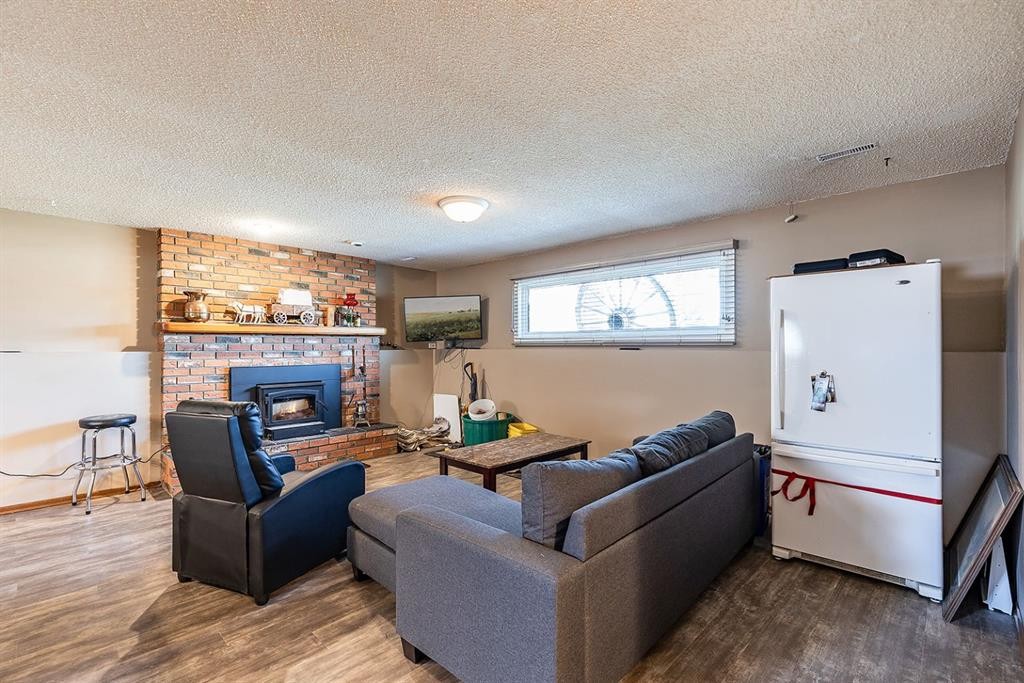 9 Rossmere Avenue Se, Medicine Hat, AB - Indoor Photo Showing Living Room With Fireplace
