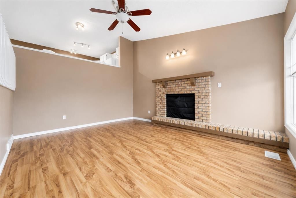 107 Sprague Way Se, Medicine Hat, AB - Indoor Photo Showing Other Room With Fireplace