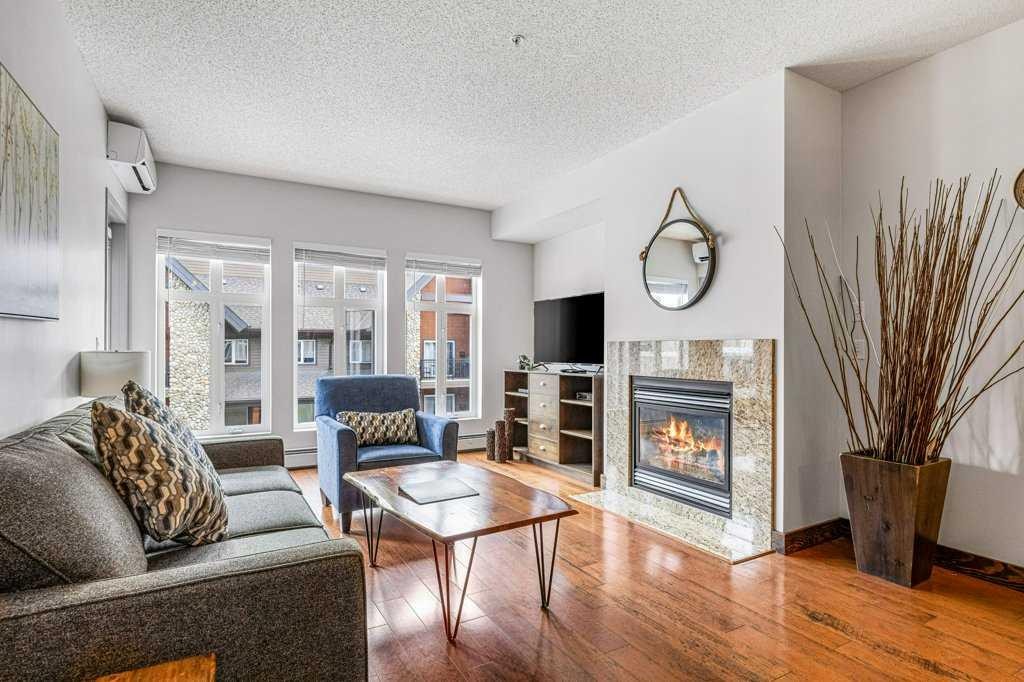 306-1151 Sidney Street, Canmore, AB - Indoor Photo Showing Living Room With Fireplace