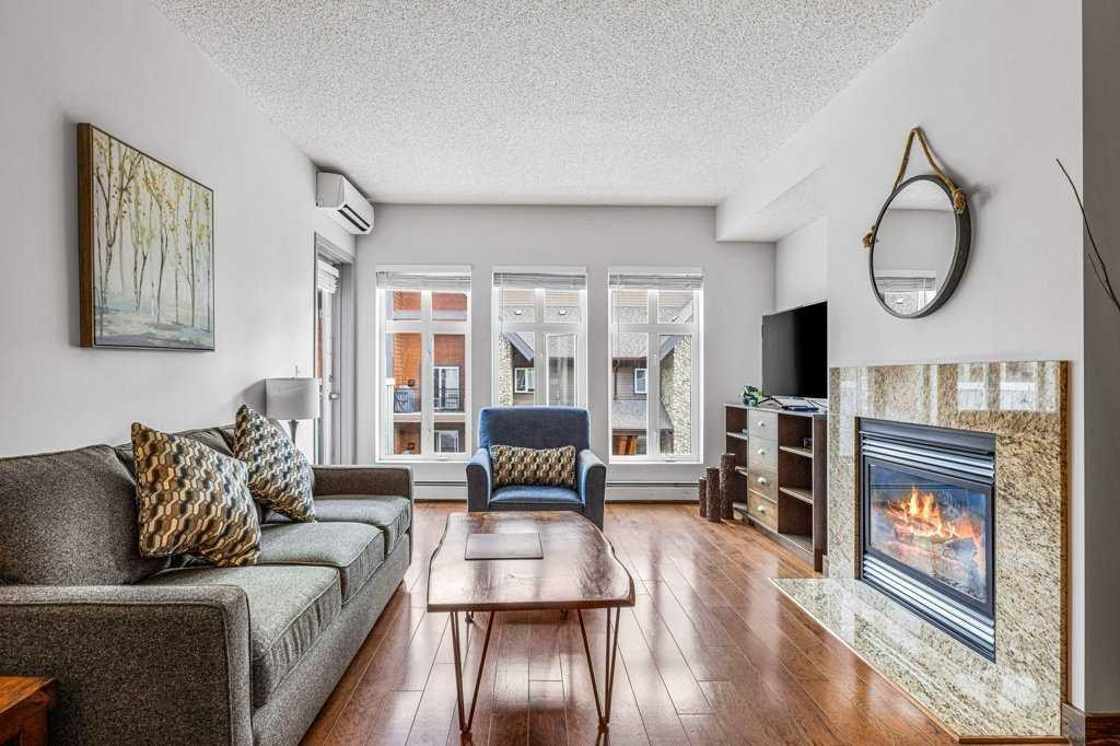306-1151 Sidney Street, Canmore, AB - Indoor Photo Showing Living Room With Fireplace