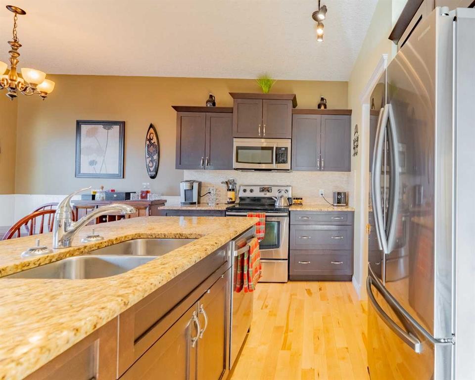 142 West Pointe Circle, Cochrane, AB - Indoor Photo Showing Kitchen With Double Sink