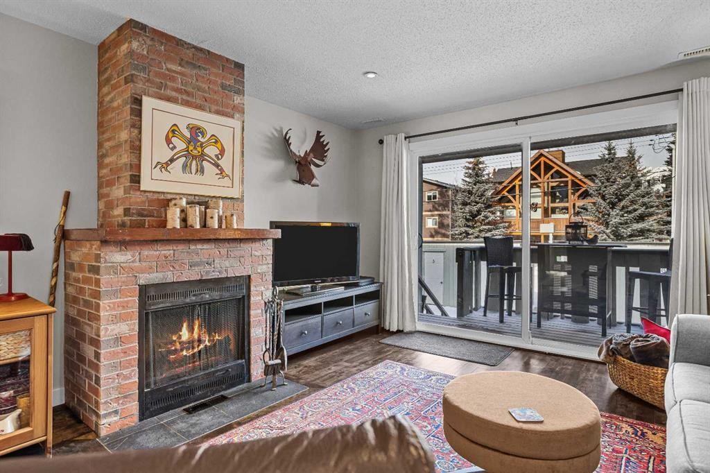 4-630 3Rd Street, Canmore, AB - Indoor Photo Showing Living Room With Fireplace