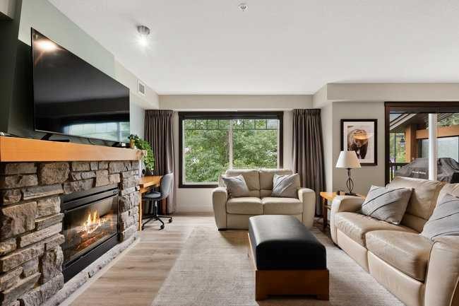 2206-250 2 Avenue, Dead Man'S Flats, AB - Indoor Photo Showing Living Room With Fireplace