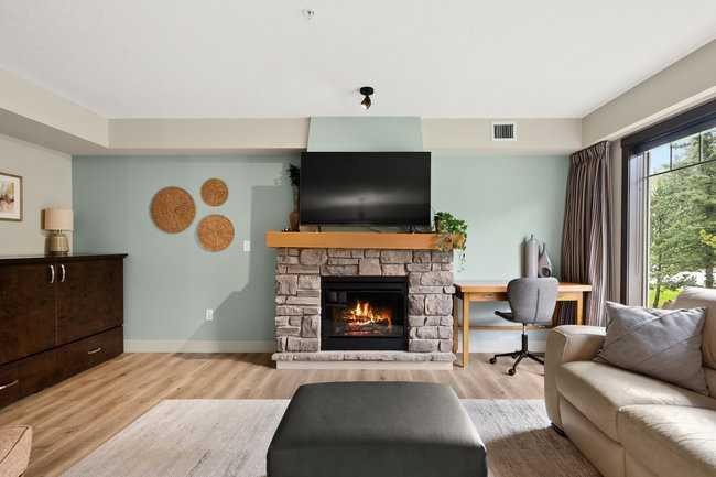 2206-250 2 Avenue, Dead Man'S Flats, AB - Indoor Photo Showing Living Room With Fireplace