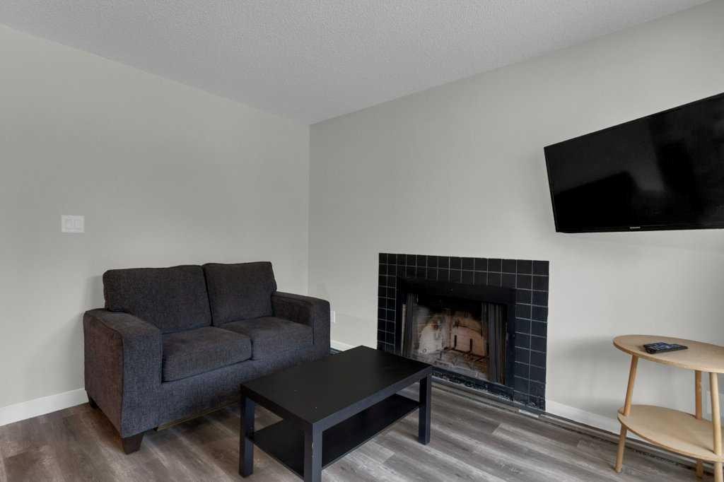 111-414 Squirrel Street, Banff, AB - Indoor Photo Showing Living Room With Fireplace