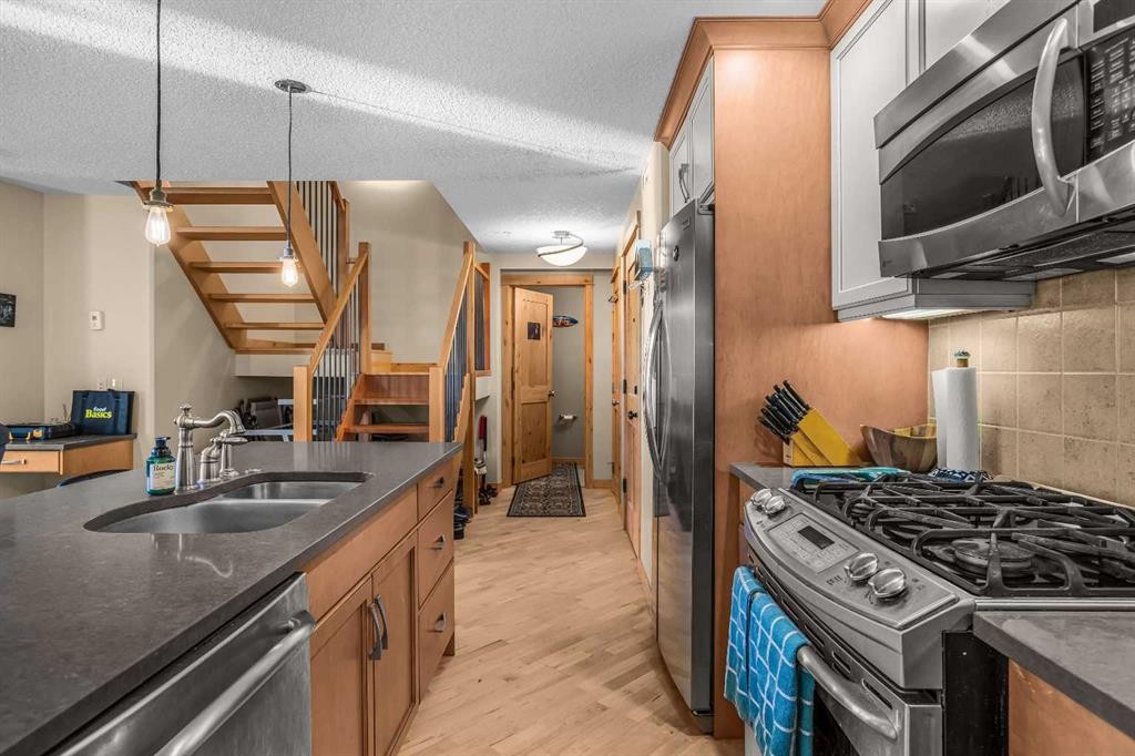 302-2100A Stewart Creek Drive, Canmore, AB - Indoor Photo Showing Kitchen With Double Sink With Upgraded Kitchen
