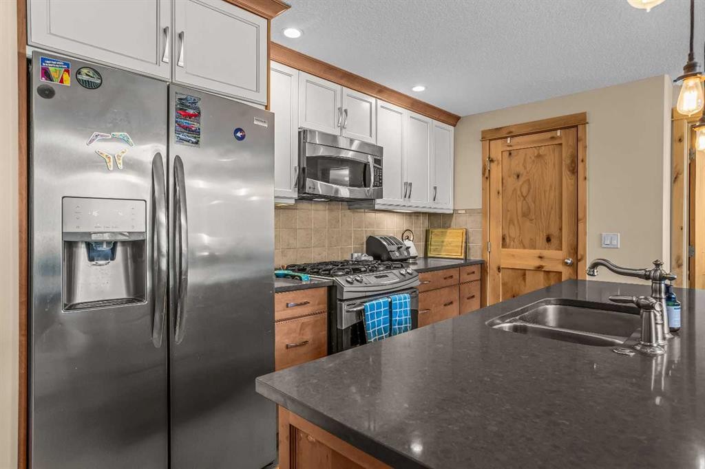 302-2100A Stewart Creek Drive, Canmore, AB - Indoor Photo Showing Kitchen With Double Sink