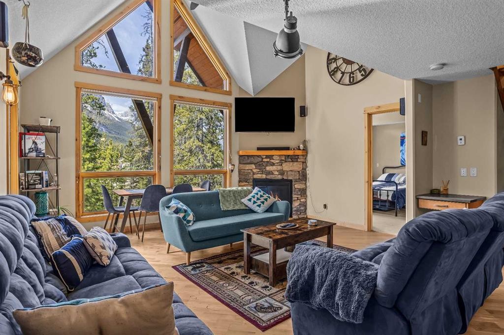 302-2100A Stewart Creek Drive, Canmore, AB - Indoor Photo Showing Living Room With Fireplace