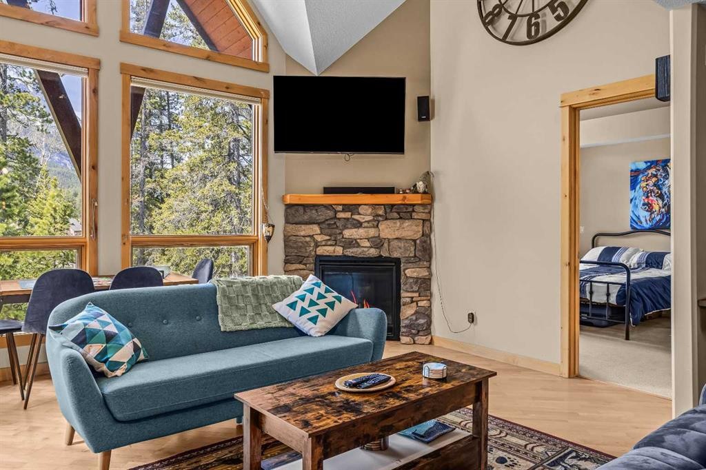 302-2100A Stewart Creek Drive, Canmore, AB - Indoor Photo Showing Living Room With Fireplace