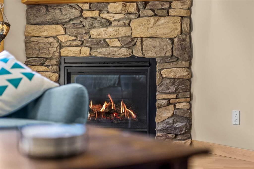 302-2100A Stewart Creek Drive, Canmore, AB - Indoor Photo Showing Living Room With Fireplace