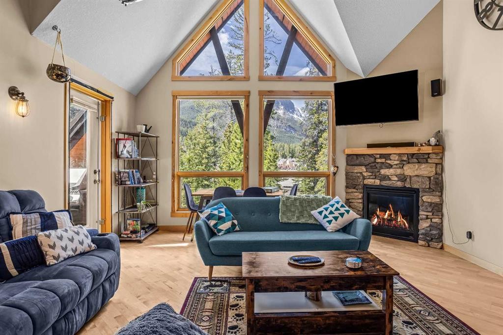 302-2100A Stewart Creek Drive, Canmore, AB - Indoor Photo Showing Living Room With Fireplace