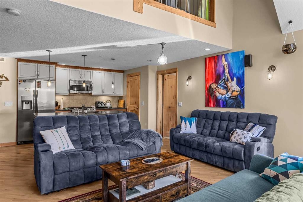302-2100A Stewart Creek Drive, Canmore, AB - Indoor Photo Showing Living Room