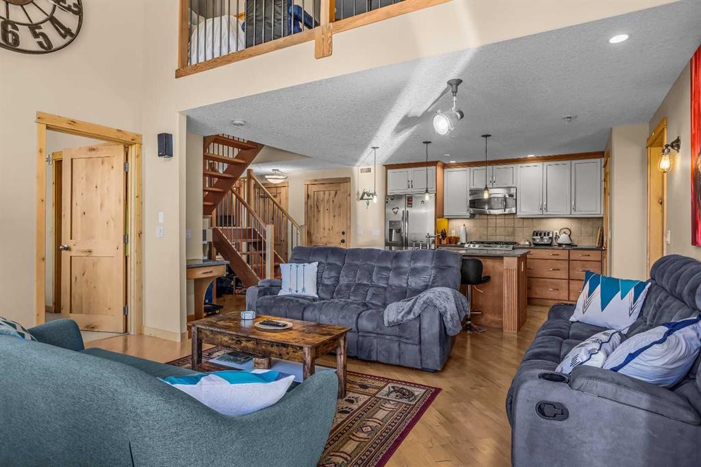 302-2100A Stewart Creek Drive, Canmore, AB - Indoor Photo Showing Living Room