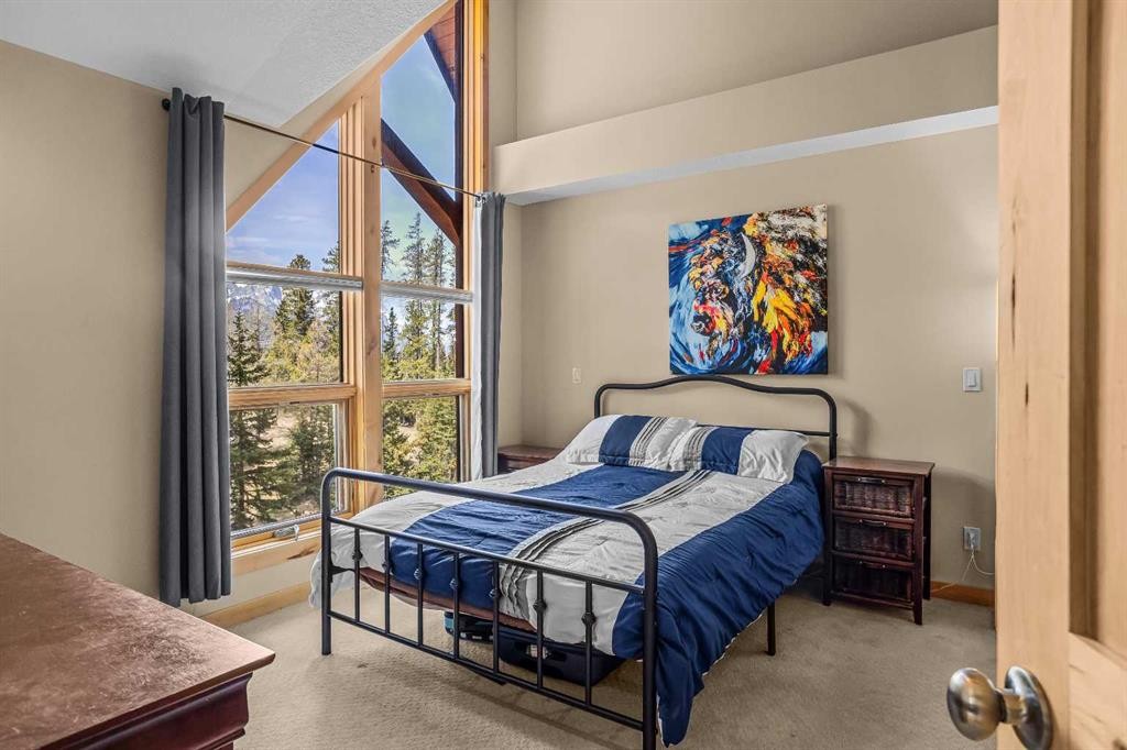 302-2100A Stewart Creek Drive, Canmore, AB - Indoor Photo Showing Bedroom
