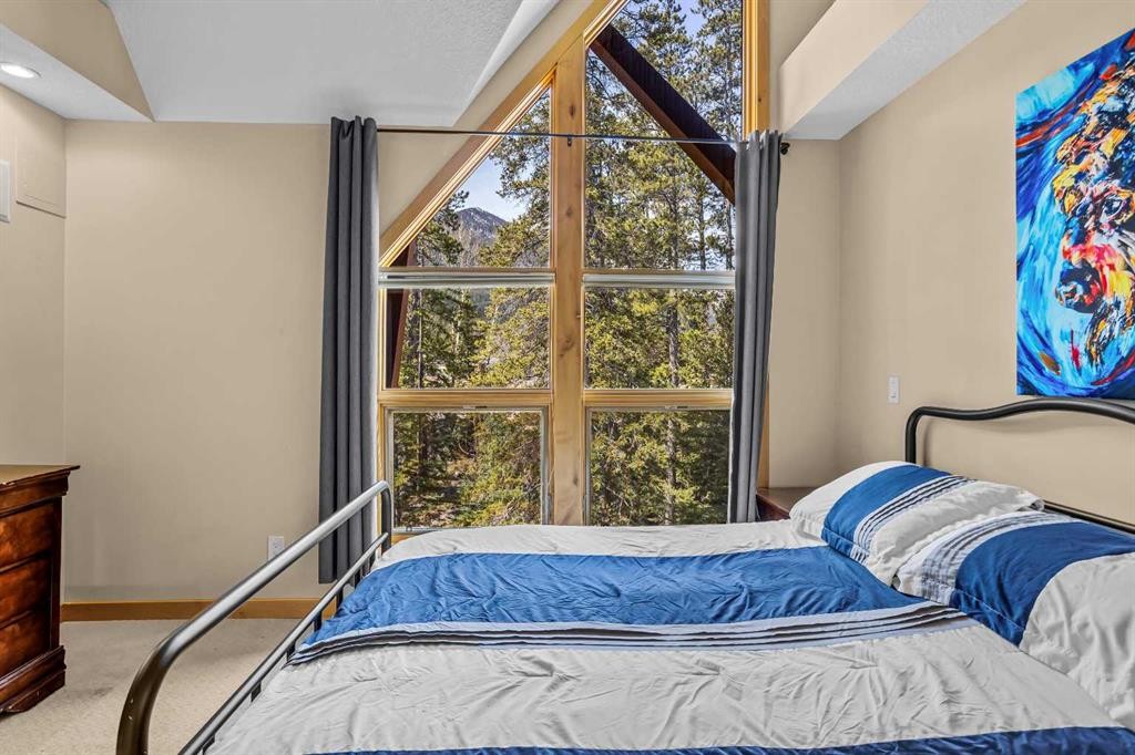 302-2100A Stewart Creek Drive, Canmore, AB - Indoor Photo Showing Bedroom