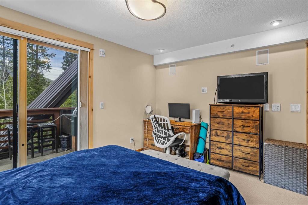 302-2100A Stewart Creek Drive, Canmore, AB - Indoor Photo Showing Bedroom
